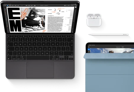 iPad Pro attached to Magic Keyboard, front exterior, space black color, rounded corners, black display bezel, open, display showing article editing app with text and photograph of a woman playing music, Airpods 4 in open case, blue Smart Folio cover on iPad Pro with Apple Pencil Pro resting atop device, cover slightly open revealing display