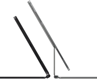 2 iPad Pro devices attached to Magic Keyboard, side exterior, thin profile, space black color with speakers and USB-C port, tilted half open, silver color, open, tilted back showing the keyboard’s floating cantilever design, speakers and microphone