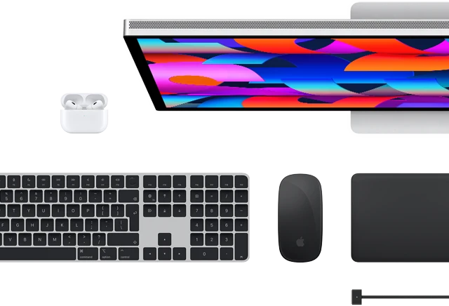Top view of Mac accessories: Studio Display, AirPods, Magic Keyboard, Magic Mouse, and Magic Trackpad