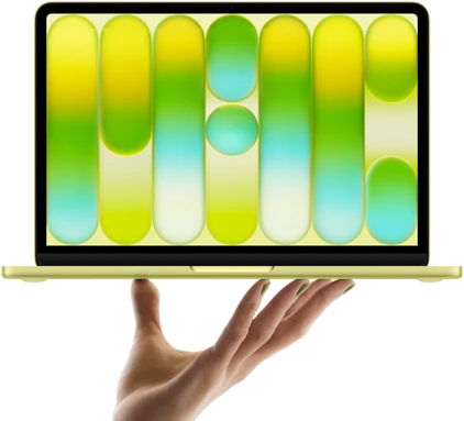 MacBook Neo in citrus color, balanced on fingertips of open hand, screen displaying colorful abstract pattern