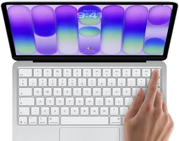 MacBook Neo, silver color, showing login screen, person's finger on Touch ID sensor in top-right corner of keyboard