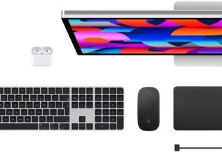 Top view of select Mac accessories: Studio Display, Magic Keyboard, Magic Mouse, Magic Trackpad, AirPods, and MagSafe charging cable