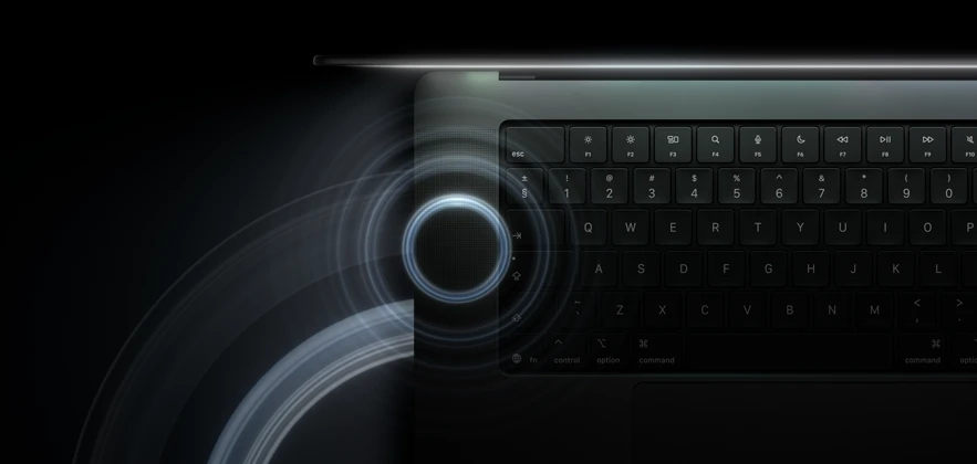MacBook Pro with PROLED XDR Display, open lid, space black color, keyboard lit by glow from display, circles depicting sonic waves emanate from top and left side of laptop body
