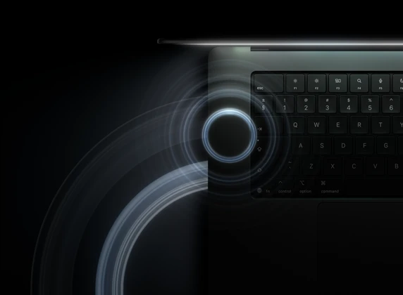 MacBook Pro with PROLED XDR Display, open lid, space black color, keyboard lit by glow from display, circles depicting sonic waves emanate from top and left side of laptop body