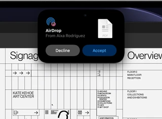 Display shows Dynamic Island with an AirDrop request in a small window over an open Adobe Acrobat file